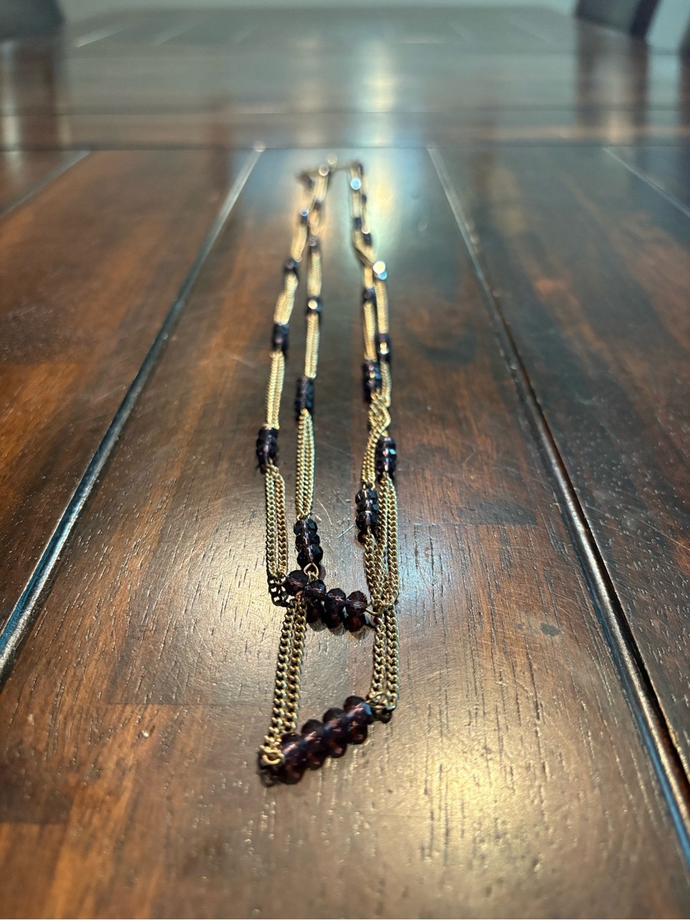 Gold and purple long beaded double strand layered necklace with dark purple bead
